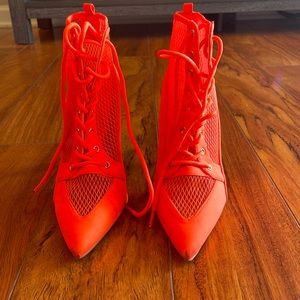 Bright orange wedge heels.